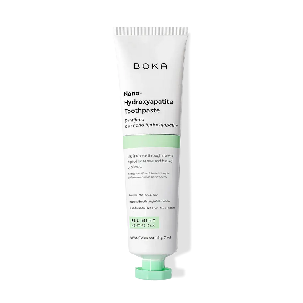 A tube of Ela Mint n-Ha Toothpaste stands upright on a white background.